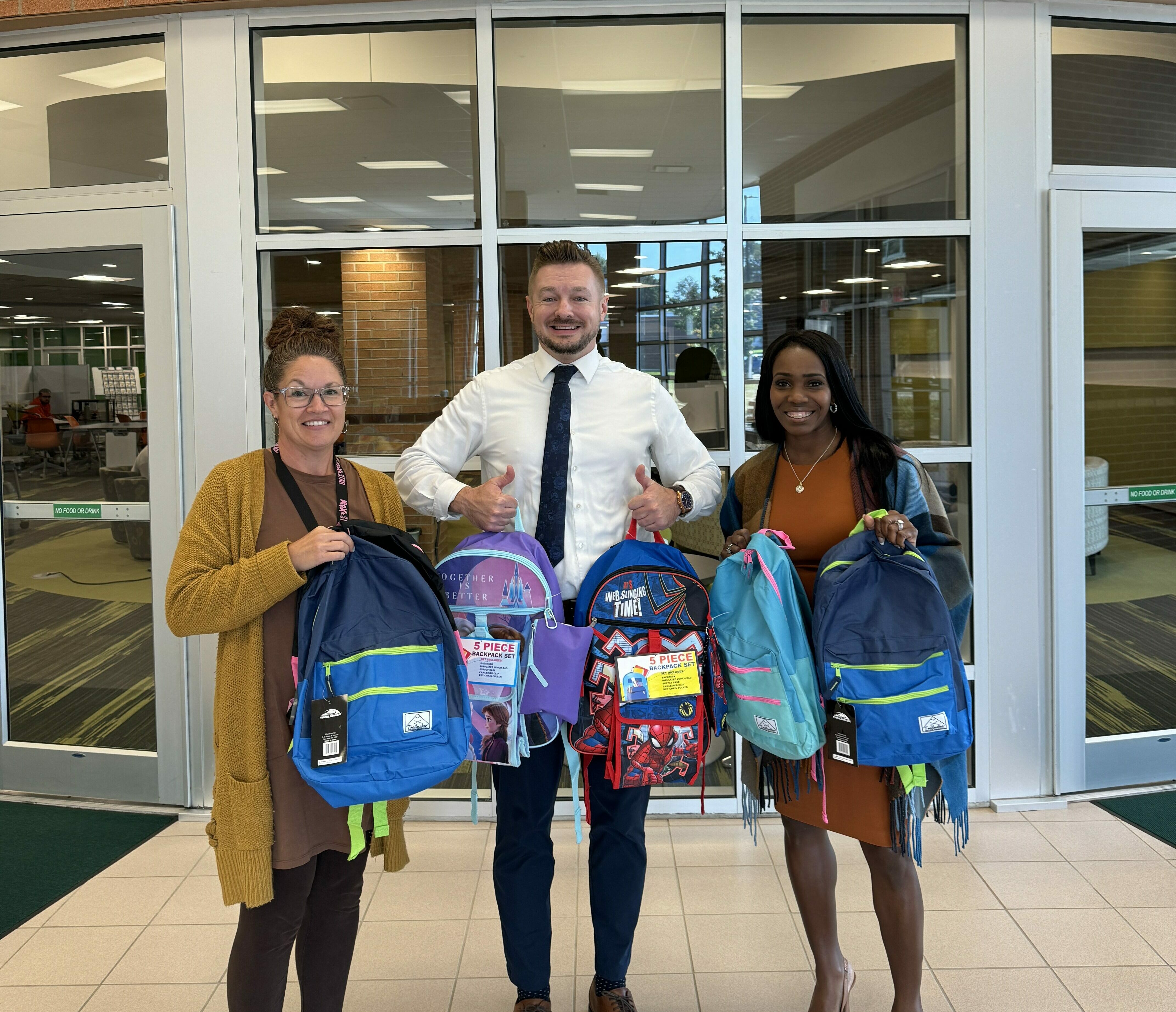 LorMet Marketing Director and Vice President at Amherst High School with backpacks